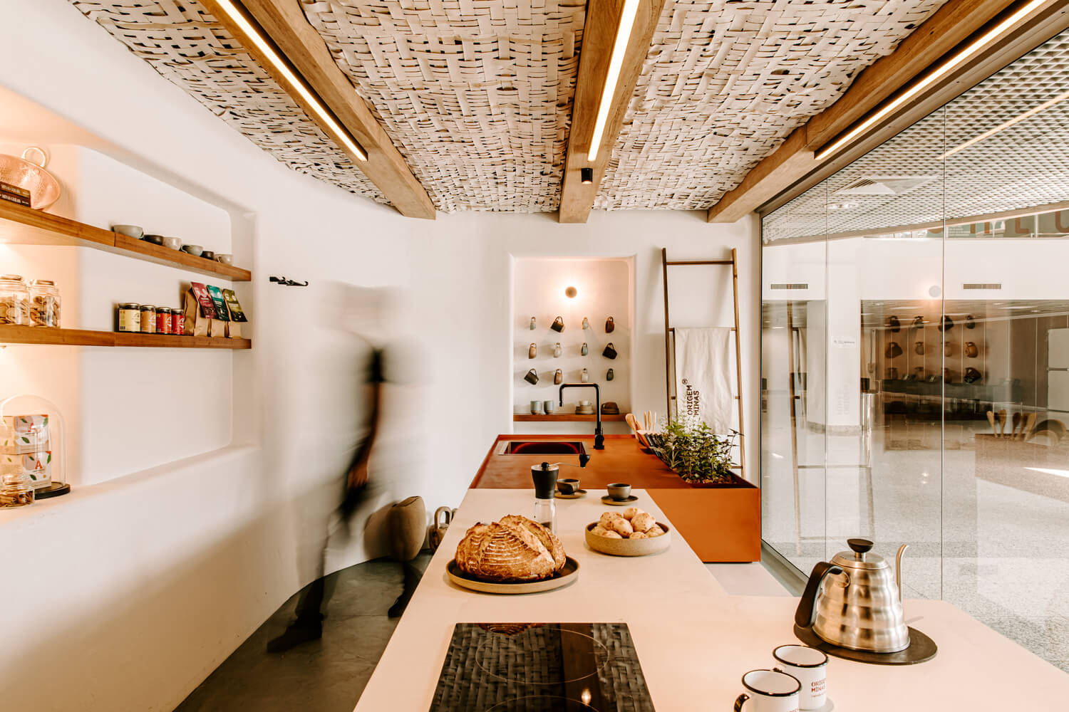  Surface-mounted LED ceiling lights on the wooden beams of this small café provide task-focused illumination with wet location and IP ratings for safe food preparation