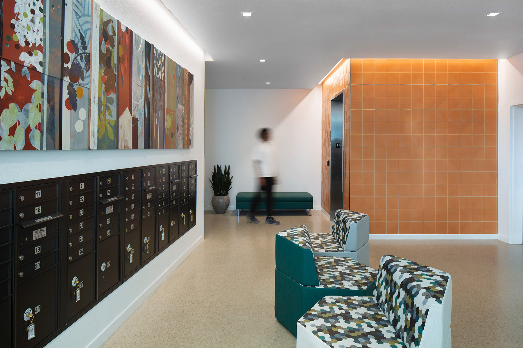 Square recessed lights provide general lighting in the Wilton Court apartments lobby, with cove lighting over the mailboxes and elevators for a refined look.